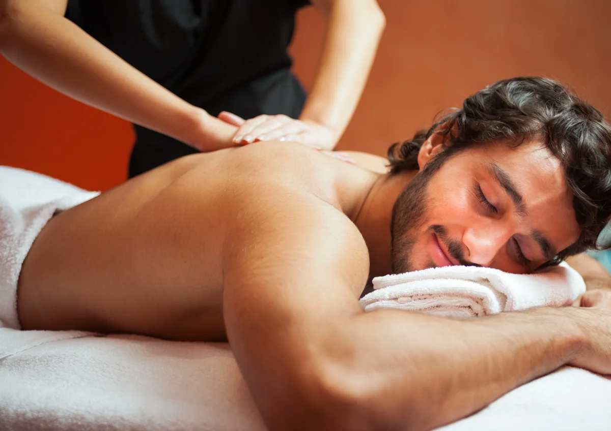 Smiling man relaxing during a back massage