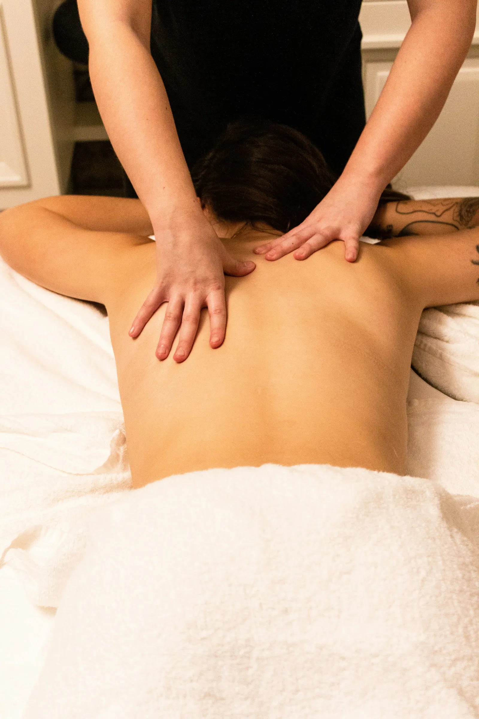 Therapist massaging tense shoulders