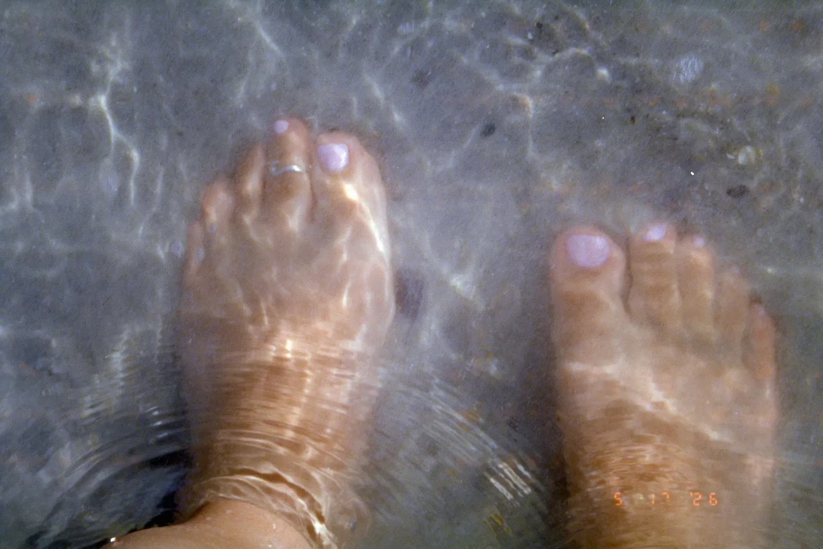 Feet in a pedicure foot bath
